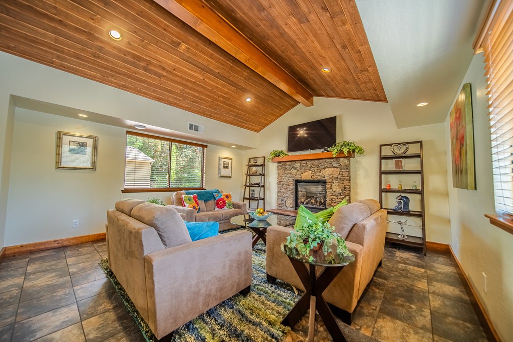 A living room with a brown couch and a fireplace.