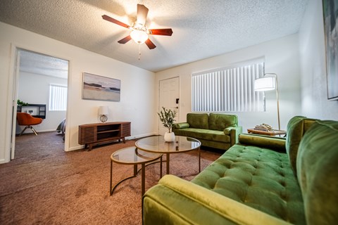 A living room with a green couch and a coffee table.
