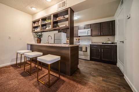 A kitchen with a bar stool and a counter.