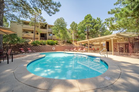 A small round pool with a white fence around it.