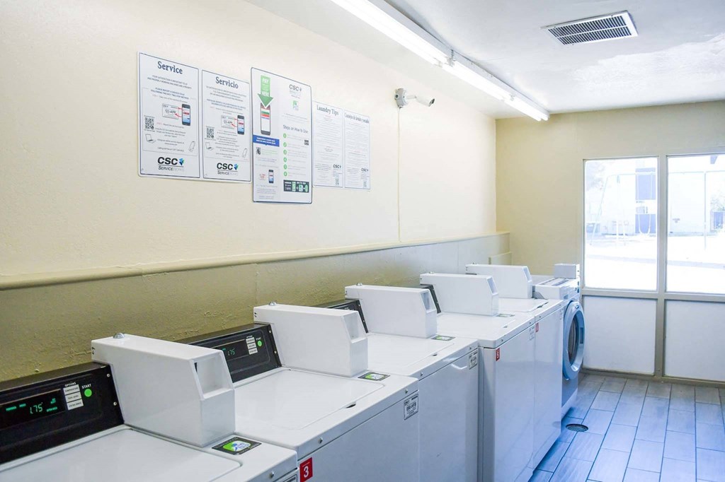 an empty laundry room with washers and dryers