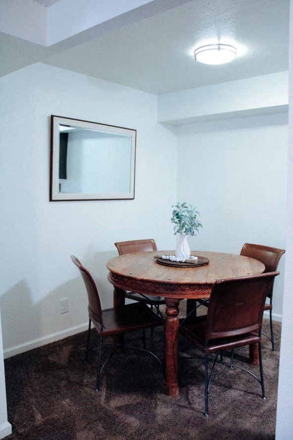 a dining room with a table and chairs