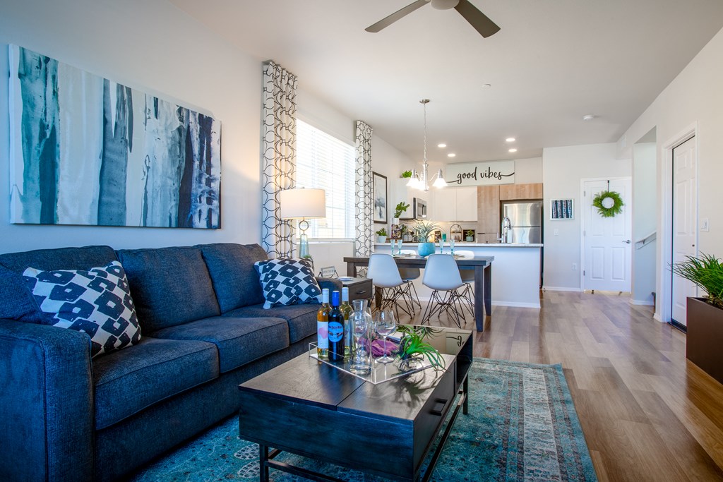 a living room with a blue couch and a coffee table