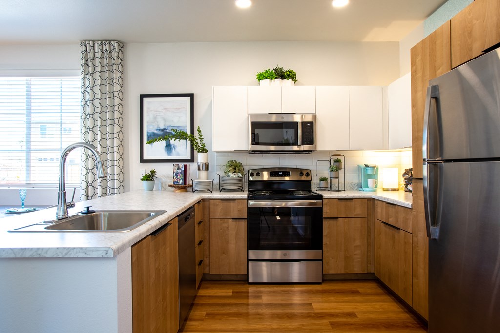 a kitchen with stainless steel appliances and wooden cabinets