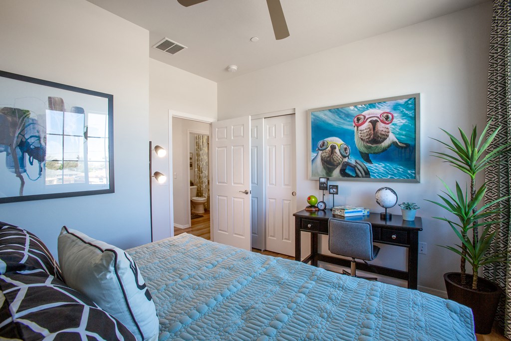 a bedroom with a large bed and a desk with a computer