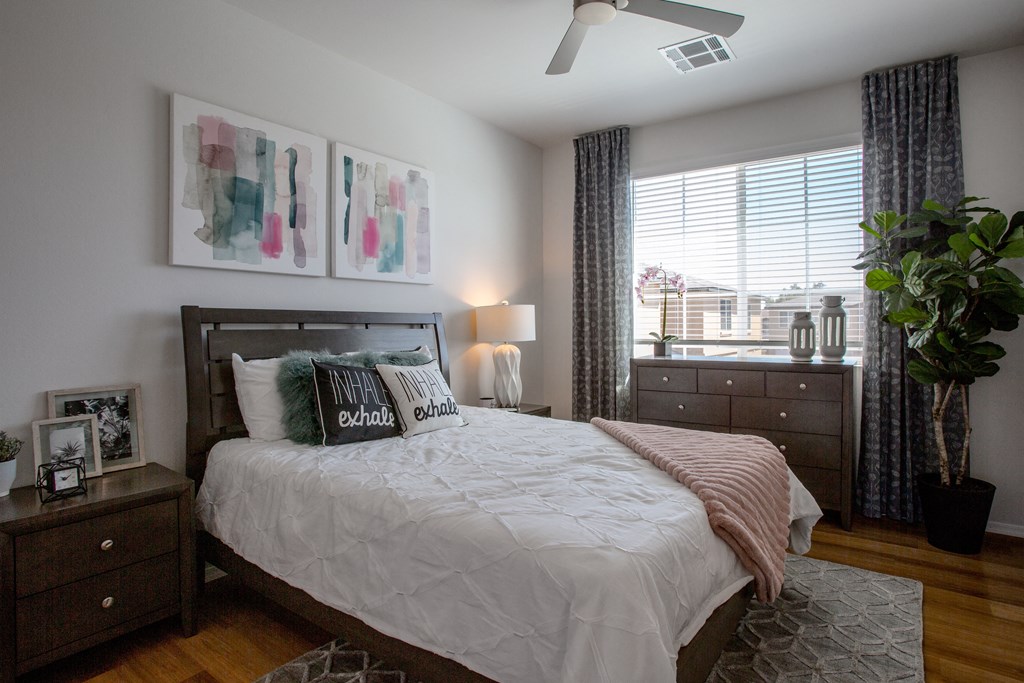 a bedroom with a bed and a large window