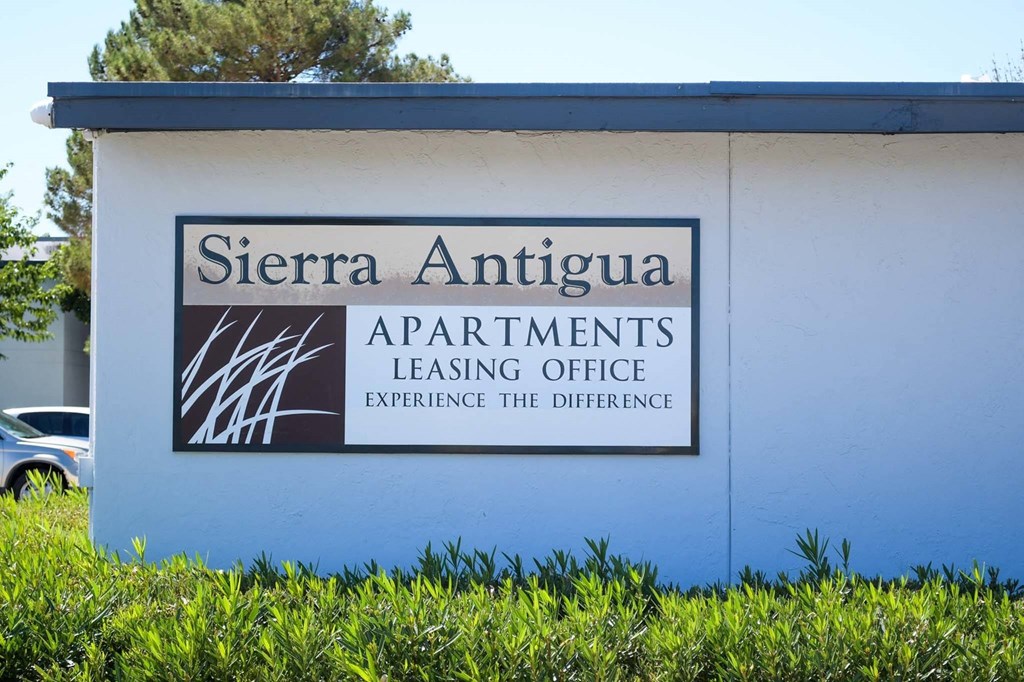 a building with a sign that says sierra antigua apartments leasing office