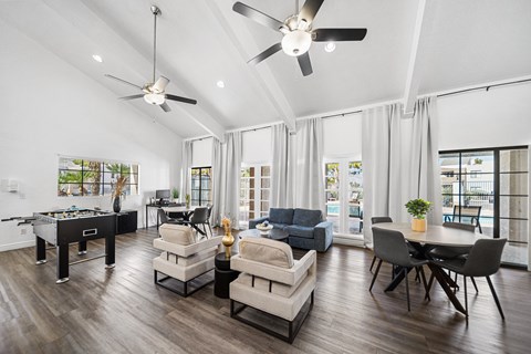 A spacious living room with a pool table and comfortable seating.