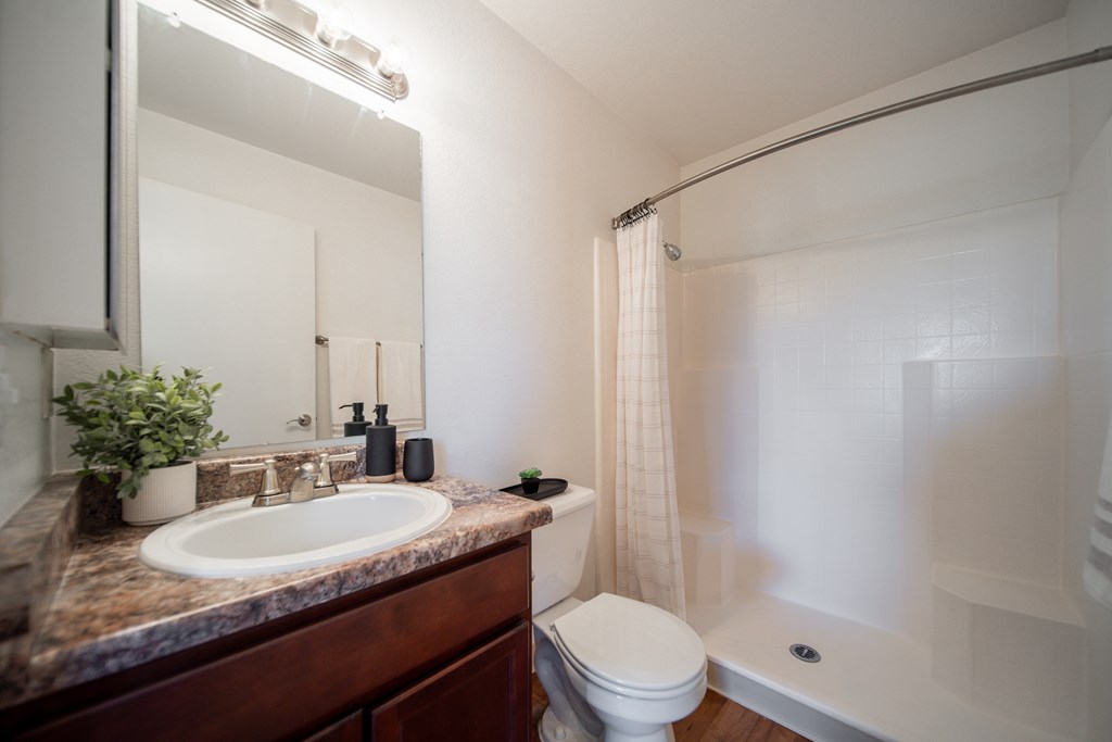A bathroom with a sink, toilet, and bathtub.