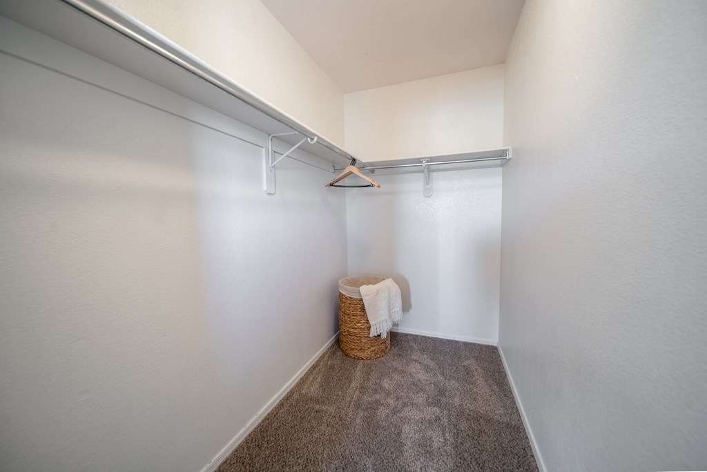 A small room with a basket and a towel hanging on a rail.