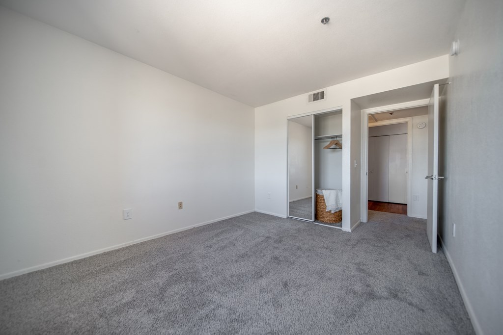 A room with a carpeted floor and white walls.