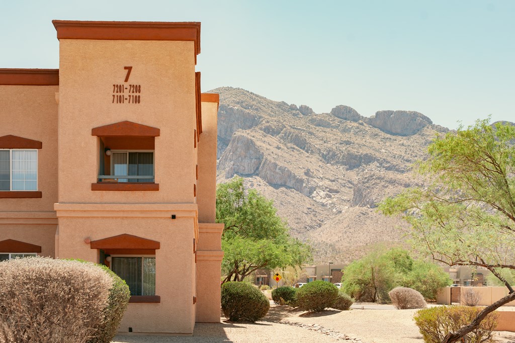 A desert-style building with a mountain in the background.
