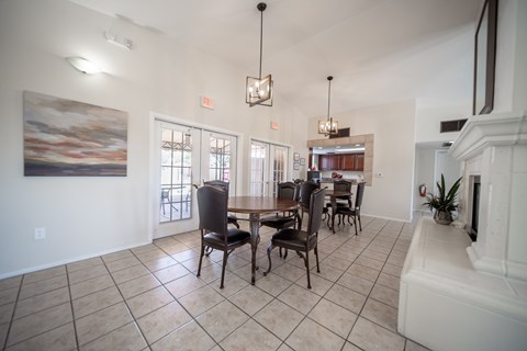 A dining room with a table set for four.
