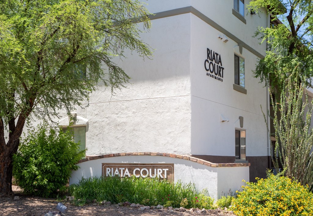 A white building with the words "Riata Court" on it.