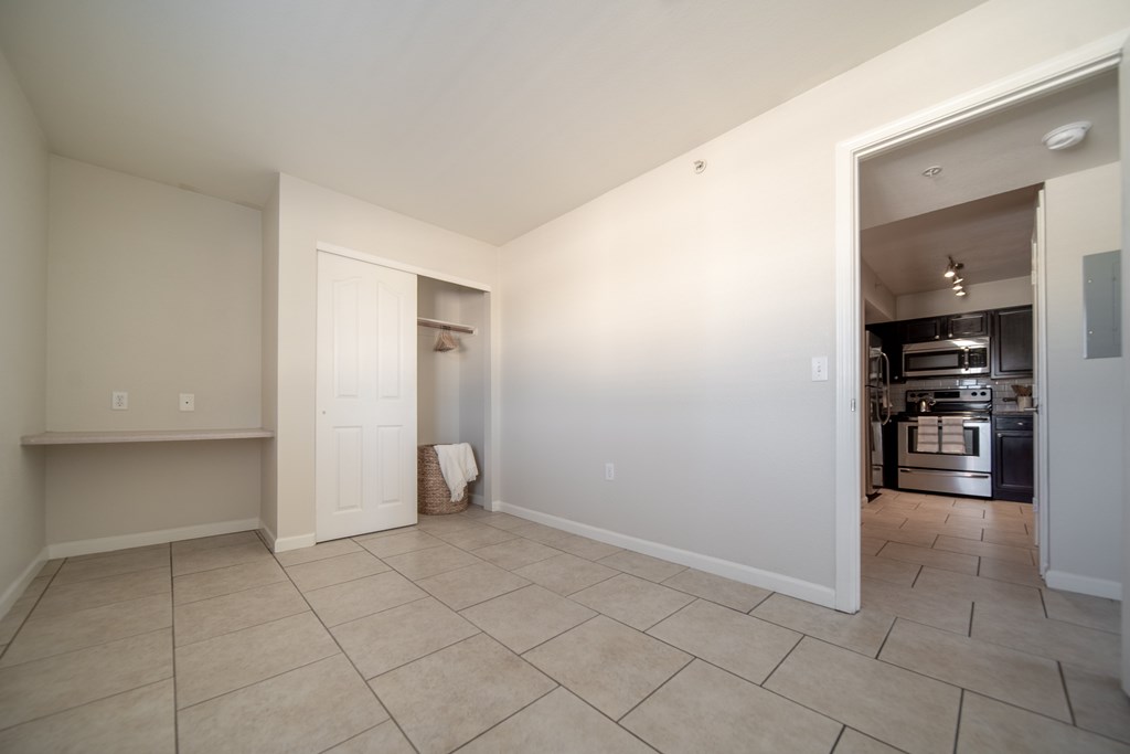 A kitchen area is visible through an open doorway.