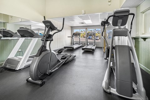 A gym with treadmills and exercise equipment.