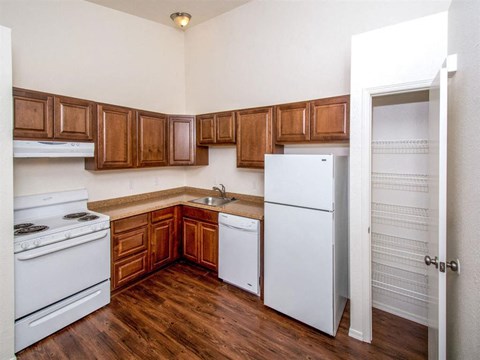 a kitchen with white appliances and wooden cabinets
