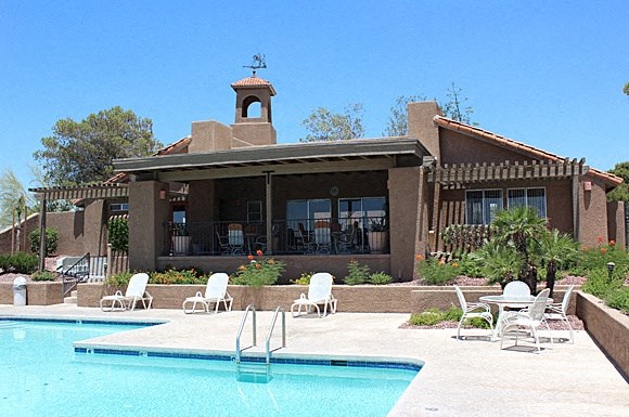 a house with a swimming pool in front of it