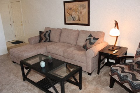 a living room with a couch and tables