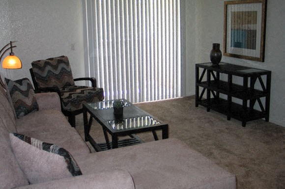 a living room filled with furniture and a large window