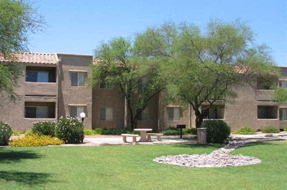 a large building with a picnic table in front of it