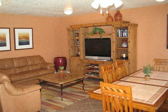 a living room with a couch a table and a television