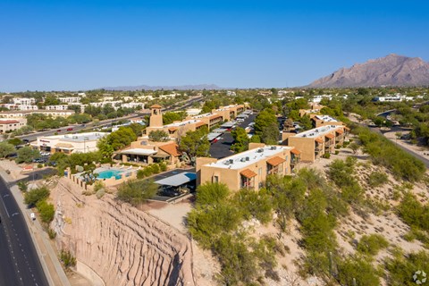 A desert landscape with a road and buildings.