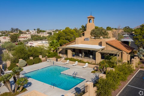 A house with a pool and a tower.