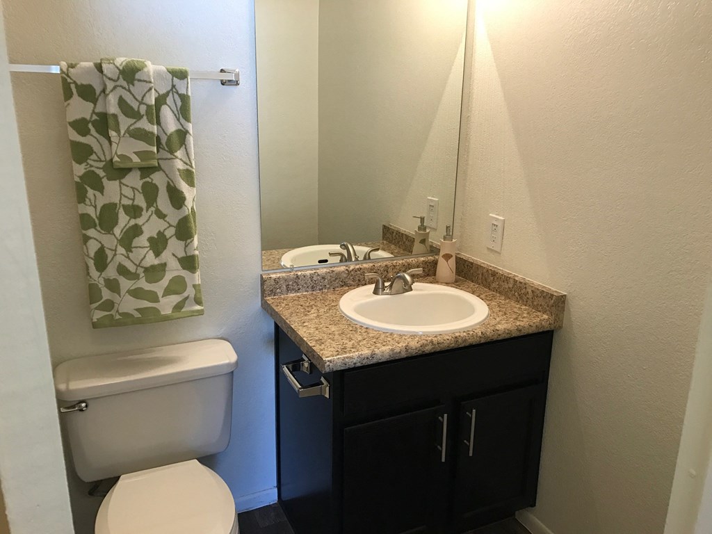 a small bathroom with a sink toilet and mirror