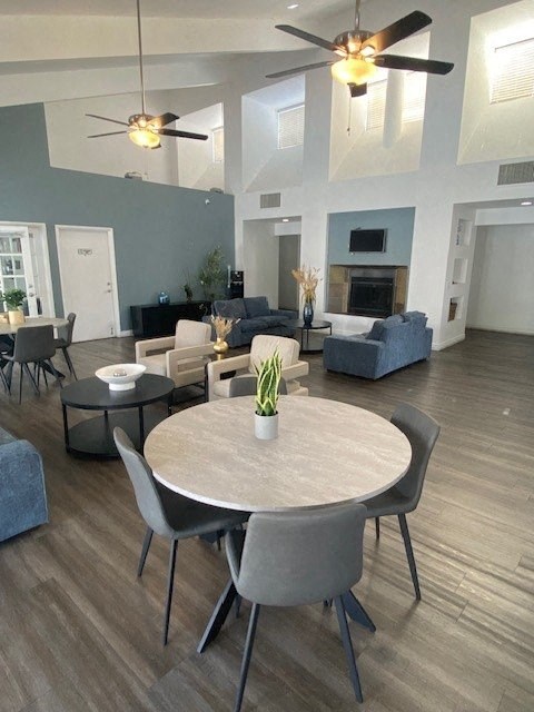 a large living room with a table and chairs