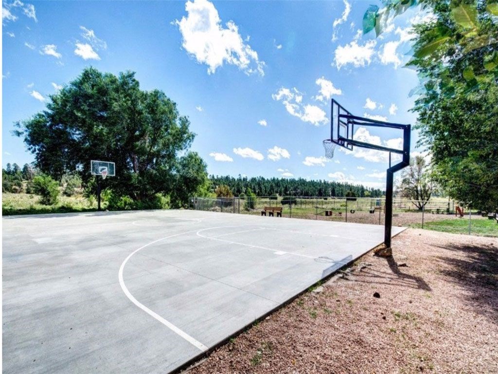 a basketball court in a park on a clear day