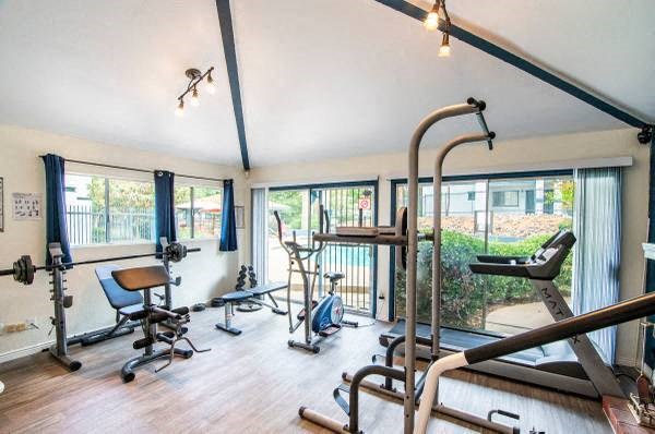 a room with a lot of exercise equipment in it