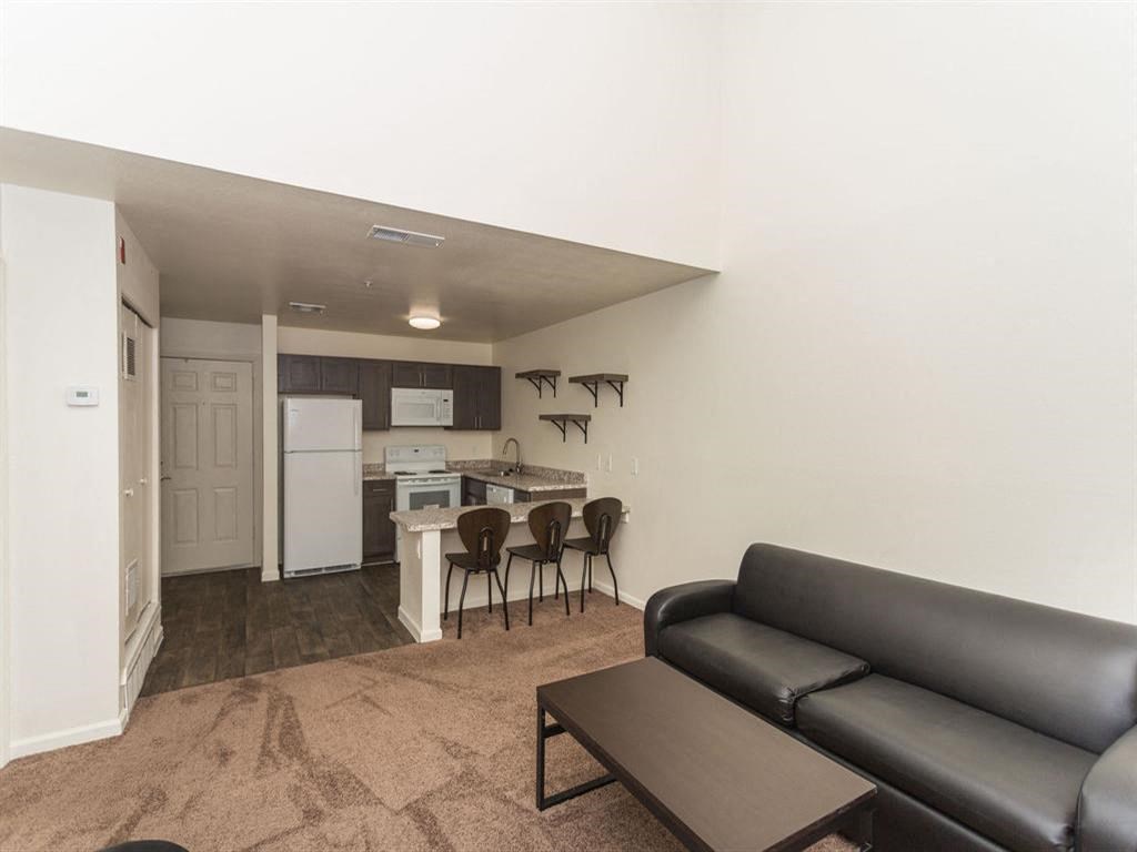 Living Room With Kitchen View at Highland Village Apartments, Flagstaff