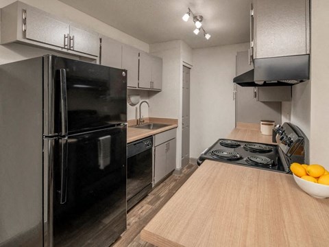 a kitchen with stainless steel appliances and a wooden table