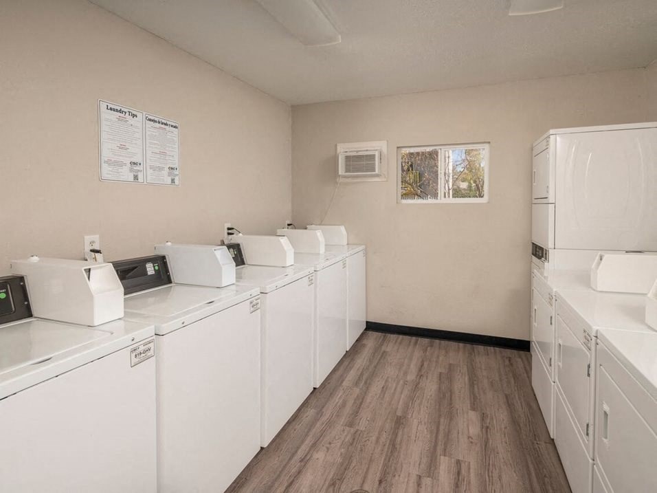 a room with a bunch of washers and dryers in it