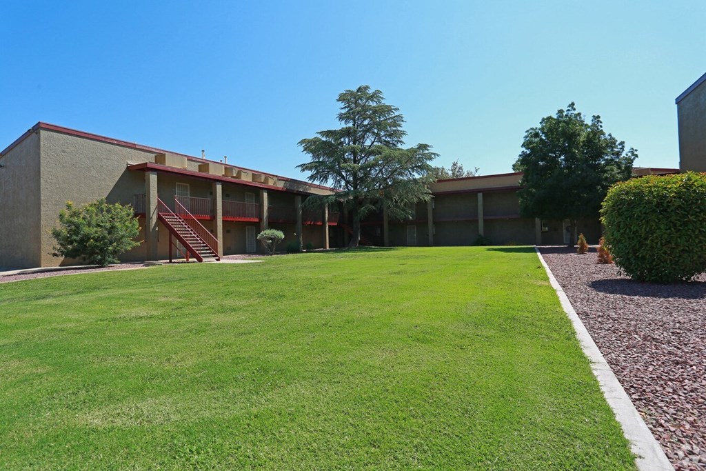 a view of the outside of a building with a lawn and a grassy yard