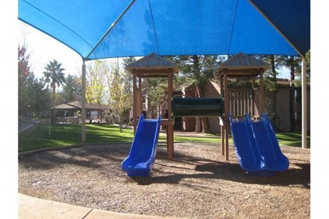 a playground with two slides and a monkey bars