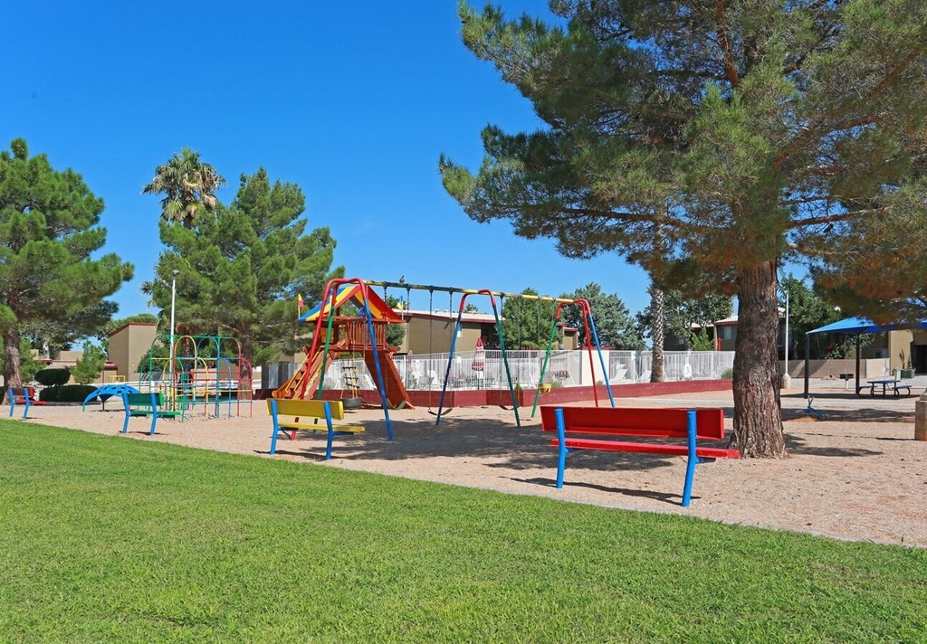 a playground with benches and a swing set