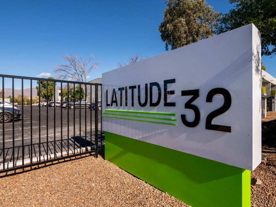 a sign in front of a gate that says latitude 33