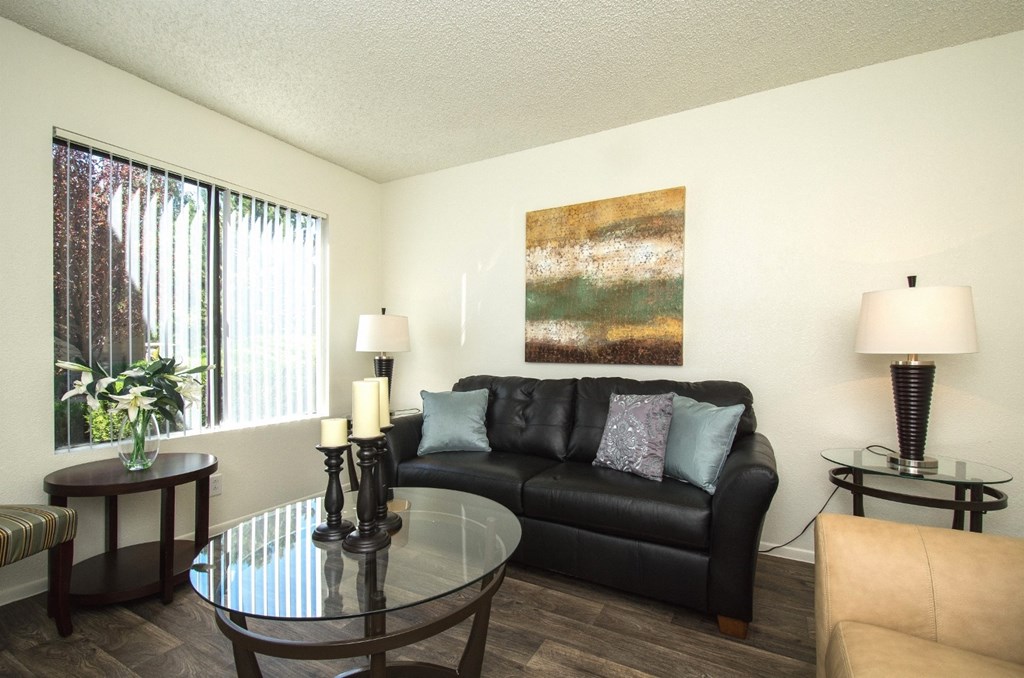 a living room with a couch coffee table and a window