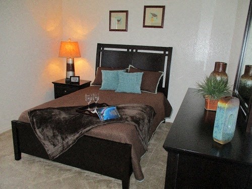 a bedroom with a bed and two night stands