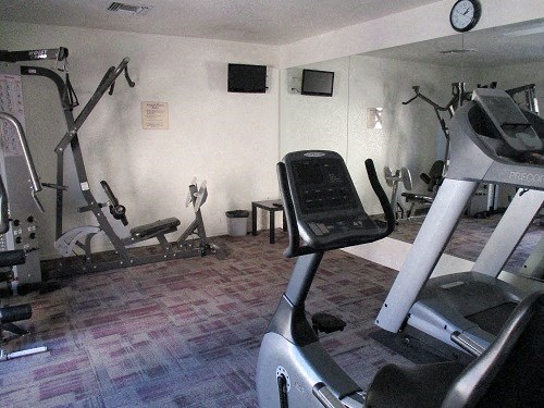 a gym with a treadmill and other exercise equipment