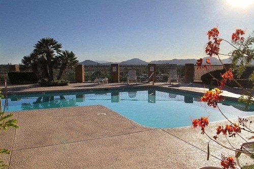a swimming pool with mountains in the background