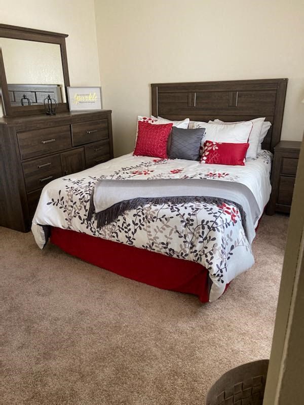 a bedroom with a bed and two dressers