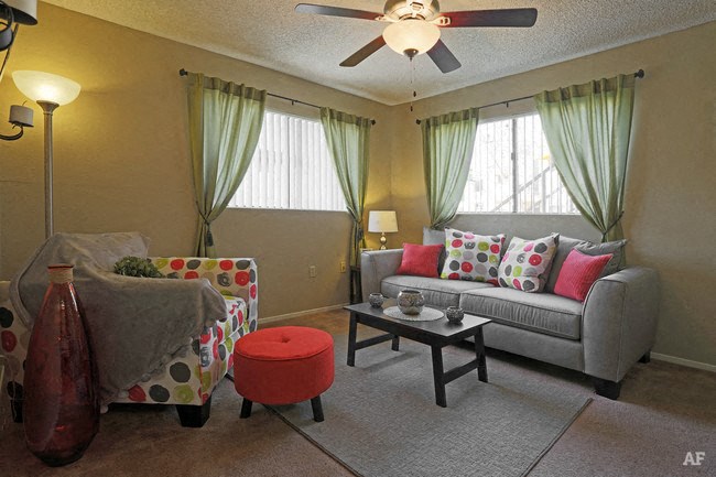 a living room with a couch and a ceiling fan