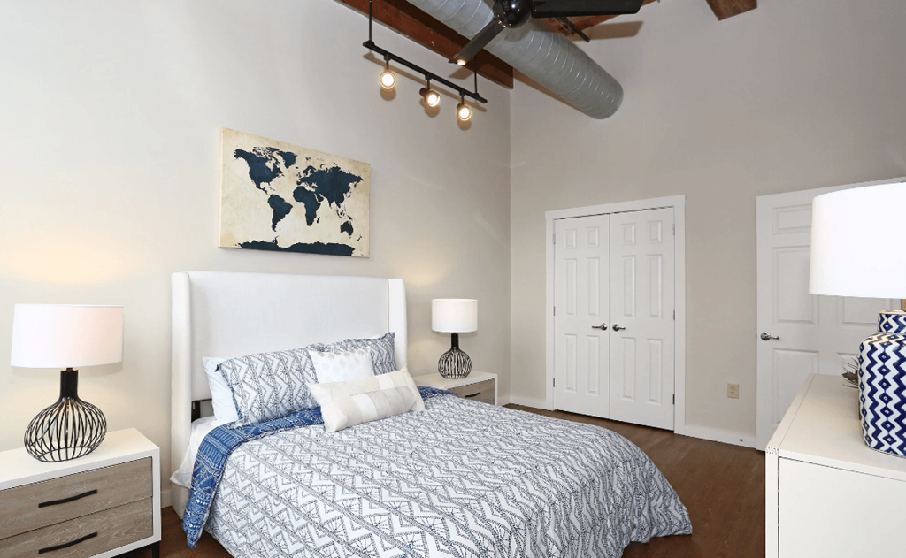 a bedroom with a bed and a ceiling fan