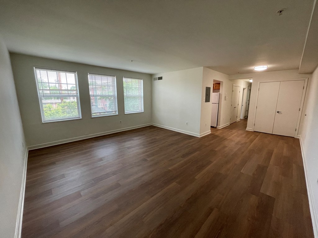 an empty living room with a hardwood floor