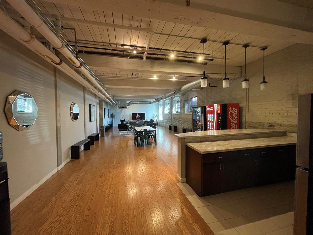 a large room with a kitchen and a table and chairs