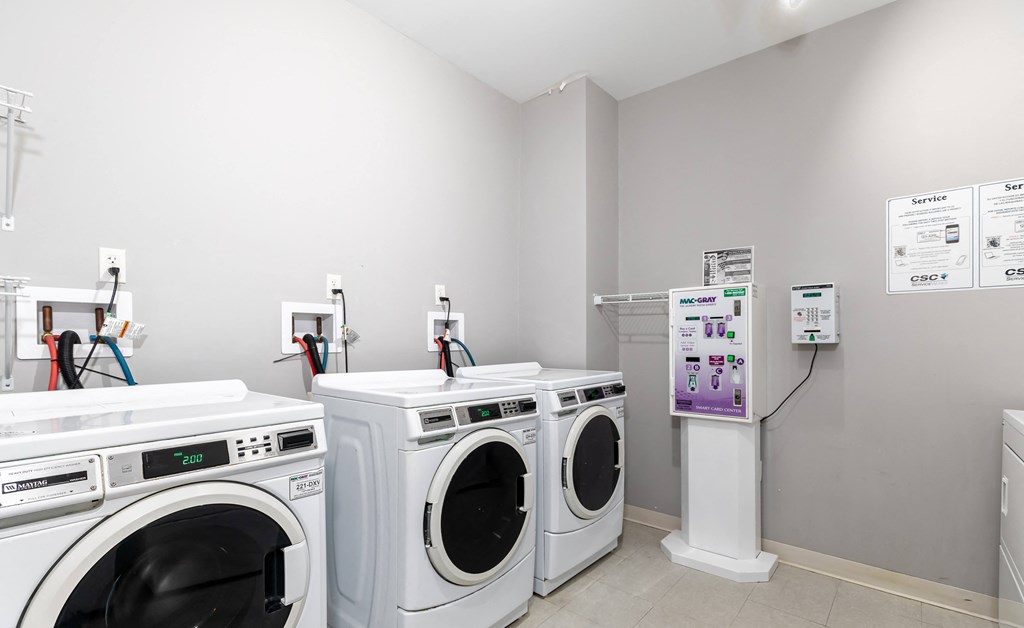 a laundry room with four washers and four washing machines