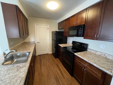 a kitchen with black appliances and granite counter tops